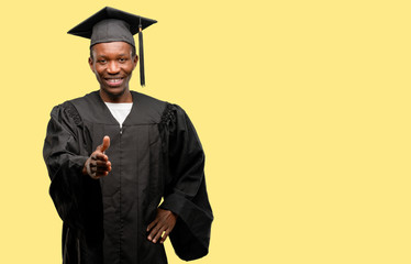 Young african graduate student black man holds hands welcoming in handshake pose, expressing trust and success concept, greeting