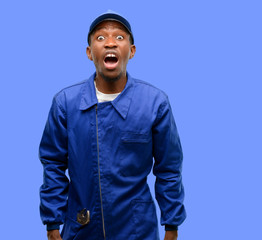 Obraz premium African black plumber man stressful, terrified in panic, shouting exasperated and frustrated. Unpleasant gesture. Annoying work drives me crazy
