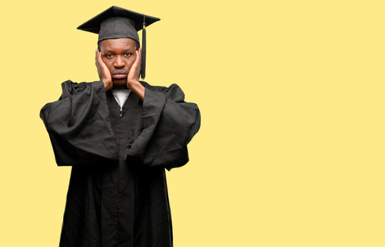 Young african graduate student black man covering ears ignoring annoying loud noise, plugs ears to avoid hearing sound. Noisy music is a problem.