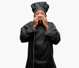 Young black cook wearing chef hat terrified and nervous expressing anxiety and panic gesture, overwhelmed