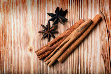 anise and cinnamon on wooden background