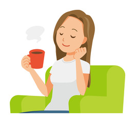 A long hair young woman is sitting on a sofa and drinking coffee