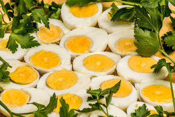 Boiled eggs cut in halves decorated with fresh parsley leaves
