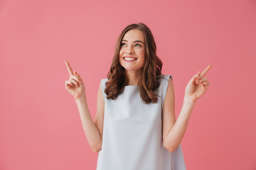 Happy young woman pointing.