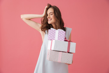 Cute excited young woman holding gift present surprise.