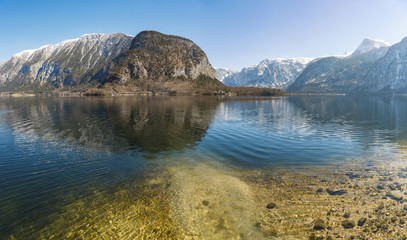The reflection of snow mountain landscape in a lake at Hallstatt, Austria