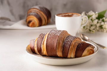 Fresh croissants. French pastries. Breakfast with croissants and tea, coffee.