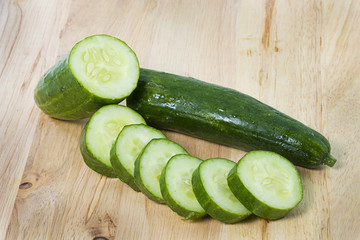 Cucumber slices on wooden background