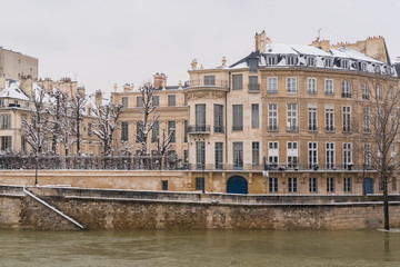 Fototapeta na wymiar Paris under the snow and floods, flooded quays, typcal staircase, the Seine in winter 