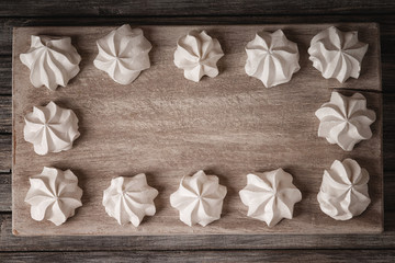 White marshmallows on wooden cutting board
