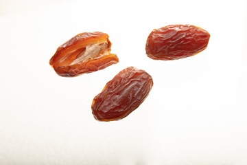 Delicious fresh organic dates on white background.