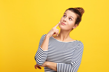 Woman against yellow wall background