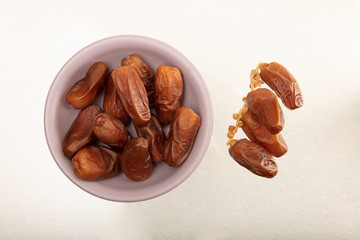 Delicious fresh organic dates on white background