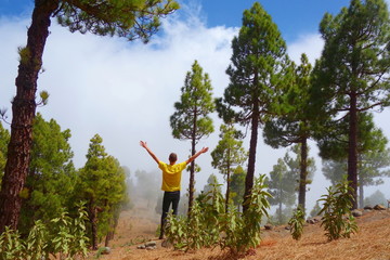 Young man on the top of a volcano which is a part of a hiking trail GR131 Ruta de los Volcanes leading from Fuencaliente to Tazacorte on La Palma, Canary Islands, Spain © Tom