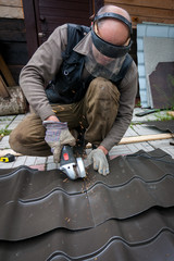 working sawing metall sheet with angle grinder