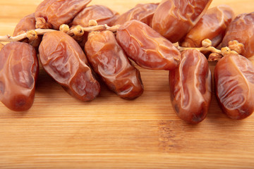 Dried dates on wooden background. palm fruit.