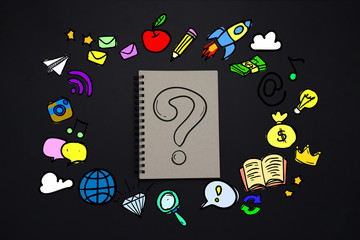 Notepad with Question Mark and Bright Icons around on a Dark Background. Creative concept work and creativity