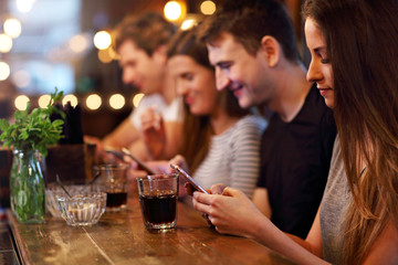 Group Of Friends Enjoying Meal In Restaurant