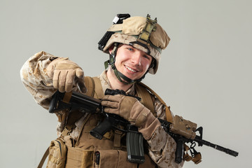 Soldier in camouflage holding rifle