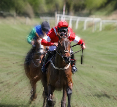 Lead race horse and jockey galloping at speed towards the finish line
