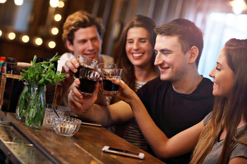 Group Of Friends Enjoying Meal In Restaurant