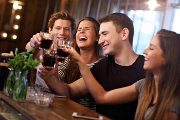 Group Of Friends Enjoying Meal In Restaurant