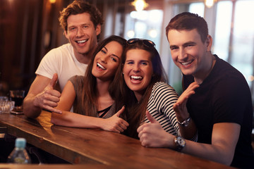 Group Of Friends Enjoying Meal In Restaurant