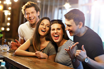 Group Of Friends Enjoying Meal In Restaurant