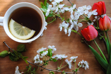 A cup of tea with lemon and flowers