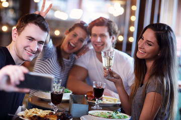 Group Of Friends Enjoying Meal In Restaurant