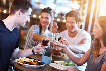 Group Of Friends Enjoying Meal In Restaurant