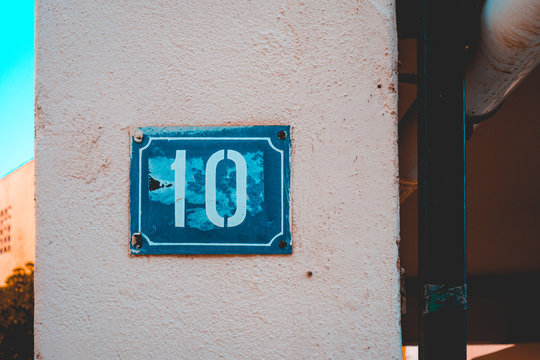 Blue Number 10 Door Sign On White Facade