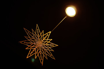 Decorative golden star for interior decoration. New Year's snowflake.