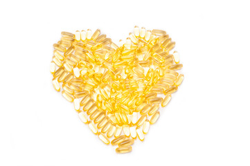  Fish oil capsules in heart shape on white background