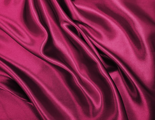 Smooth elegant pink silk or satin luxury cloth texture as abstract background. Luxurious background design