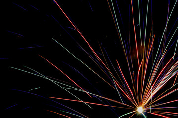 Multicolored firework lights on a black background.