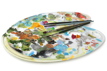Palette with oil paint and paintbrushes