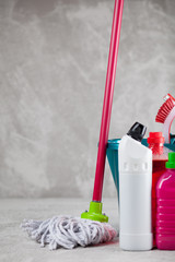 Cleaning supplies on grey background