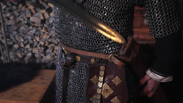 Close-up of the hands of a viking sheathed sword.