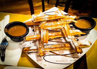 Churros the best Spanish dessert, with chocolate sauce.