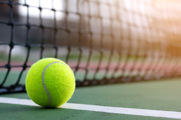 Close up tennis ball on blur net with copy space