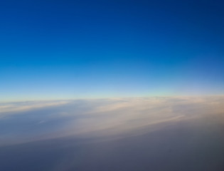 Fototapeta premium View from airplane window, clouds like carpet.