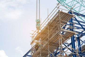 Lots of tower Construction site with cranes and building with blue sky background,scaffolding for...