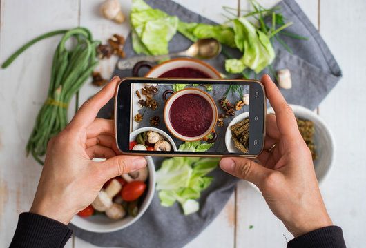 Phone photography of food for social networks. Smartphone photo of beetroot soup. Russian traditional borscht. Raw vegan vegetarian healthy food