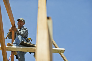 Builder cutting a piece of wood with a circular saw.
