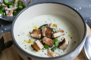 Delicious asparagus soup with bacon, fried asparagus and homemade pastries