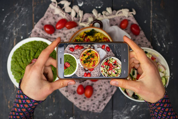 Phone photography of food for social networks.  Smartphone photo of quinoa salad with vegetables. Raw vegan vegetarian healthy food