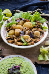 Backed potatoes and roasted mushrooms on salad leaves. Organic farm lunch or dinner. Raw vegan vegetarian healthy food