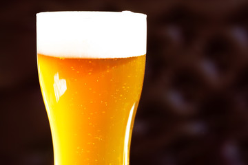 Beer in a glass in the bar is on the table close up