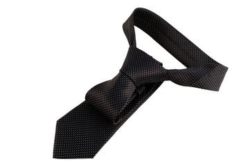 The tie is dark gray in a white dot of shiny fabric tied to a knot on a white background.